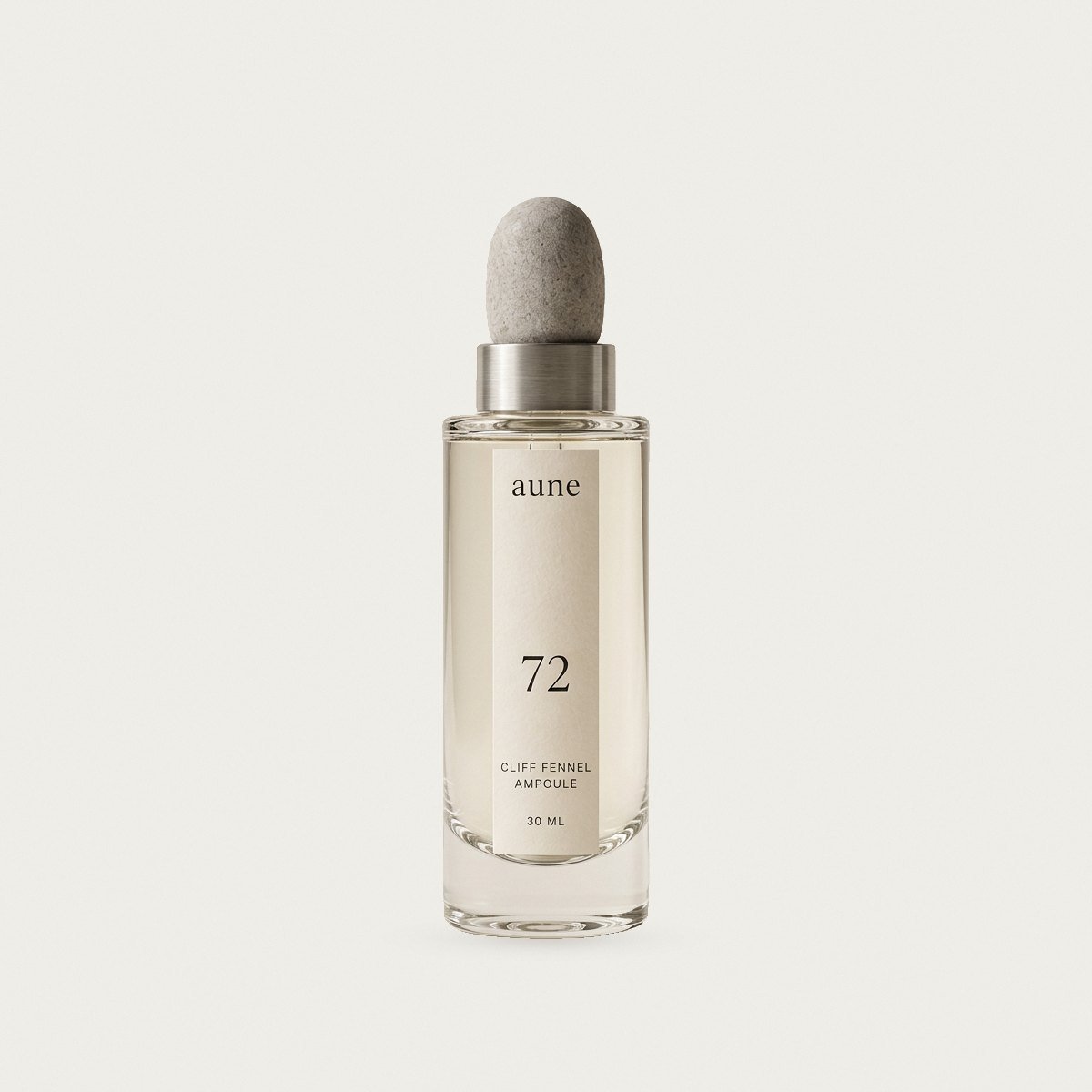 Cliff Fennel Ampoule in a clear glass dropper bottle with a stone pebble cap, on a warm white backdrop