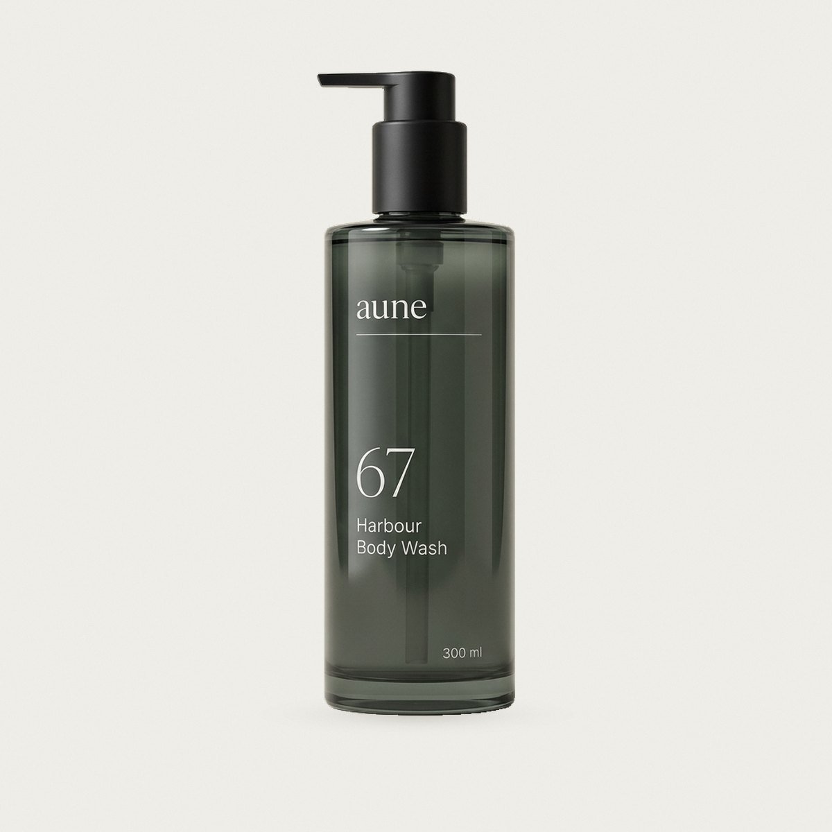 Harbour Body Wash in a smoked glass tall pump bottle, on a warm white backdrop