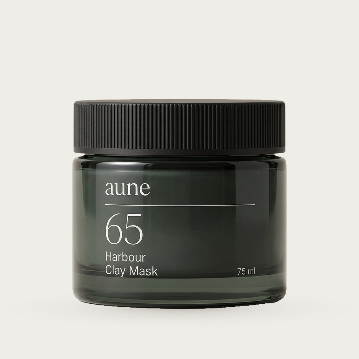 Harbour Clay Mask in a smoked glass cream jar, on a warm white backdrop