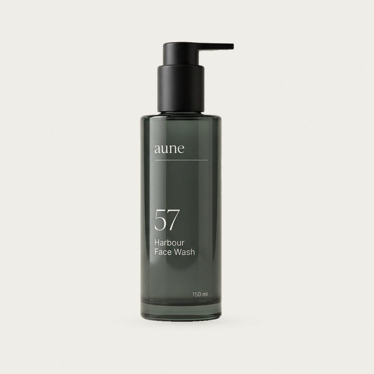 Harbour Face Wash in a smoked glass pump bottle, on a warm white backdrop