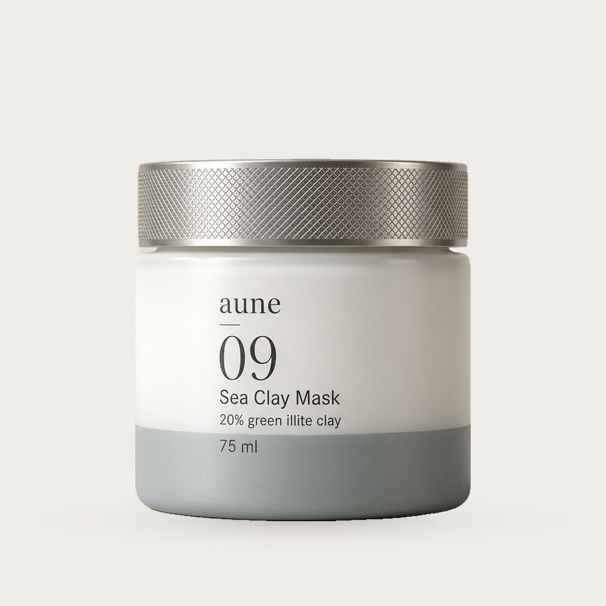Sea Clay Mask in a white glass wide jar with a sea-grey tide line, on a warm white backdrop