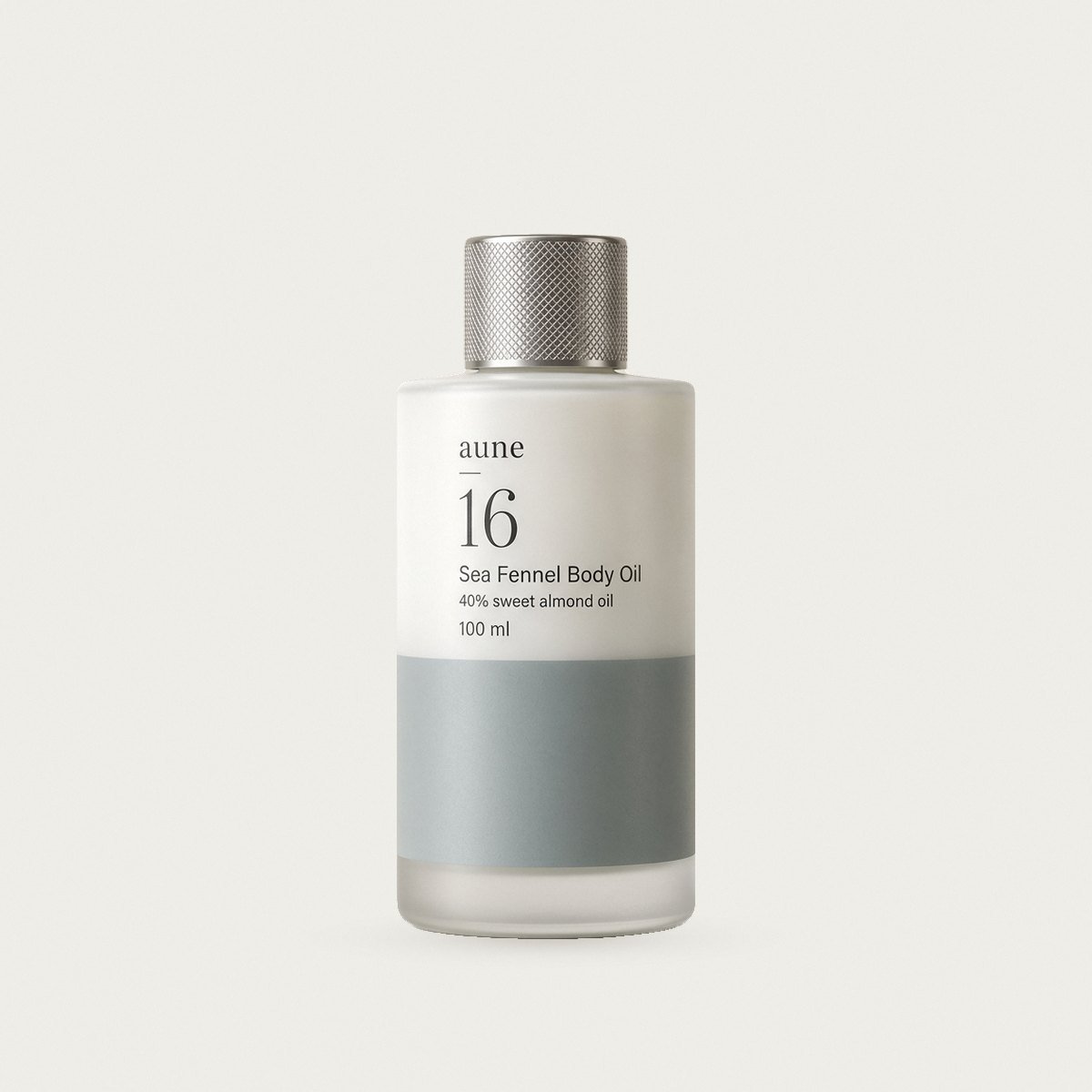 Sea Fennel Body Oil in a white glass oil bottle with a sea-grey tide line, on a warm white backdrop
